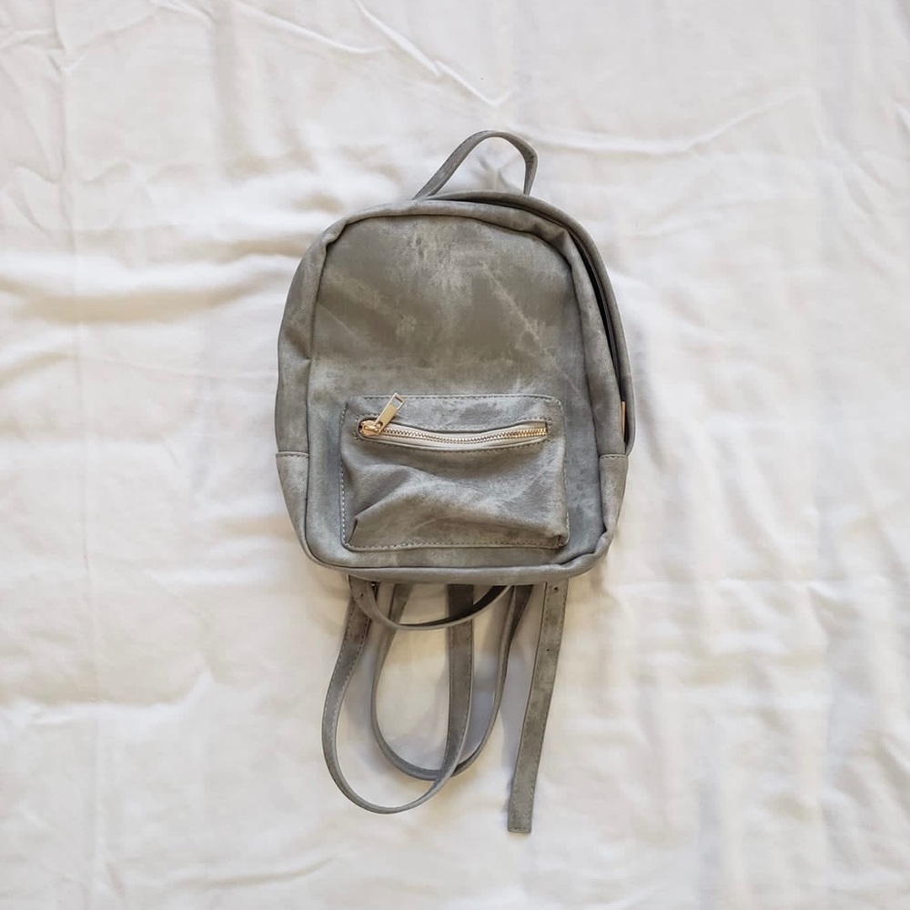 Grey backpack with gold hardware